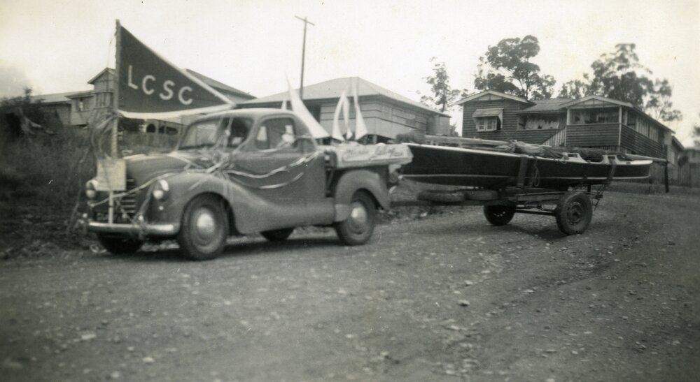 Decorated vehicle and boat, Coronation Day Parade, Lake Cootharaba Sailing Club, 2 June 1953