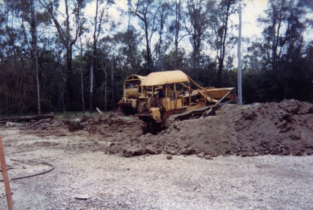 Bulldozers pulling Noosa River Ferry up onto land for survey, mid 1990s