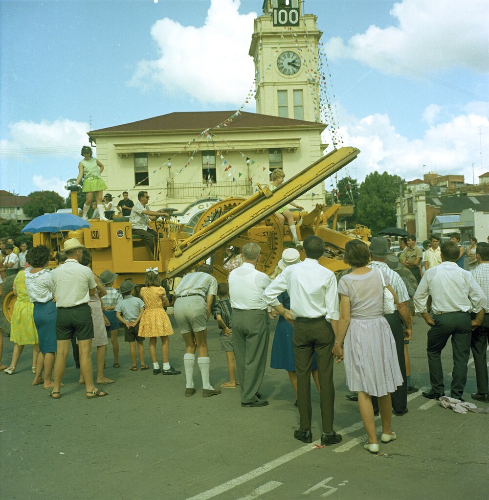 Heavy equipment passing Gympie Town Hall, Gympie Centenary Procession, Gympie, 14 October 1967