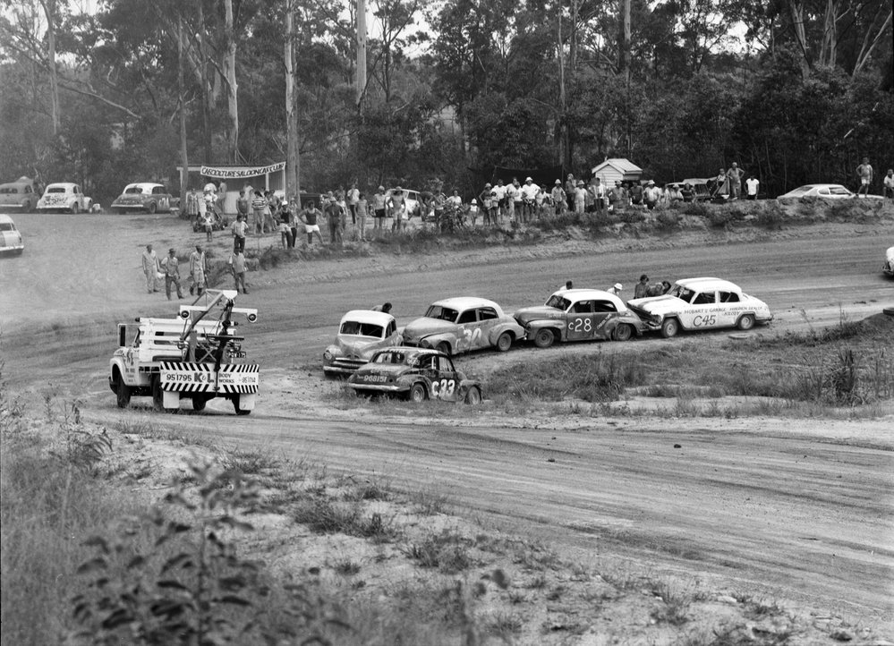 Spectators and car racing, speedway meeting, Caboolture, March 1973