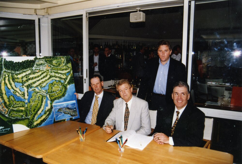 Alan Starkey (seated middle) signing development papers for Noosa Springs, ca 1992