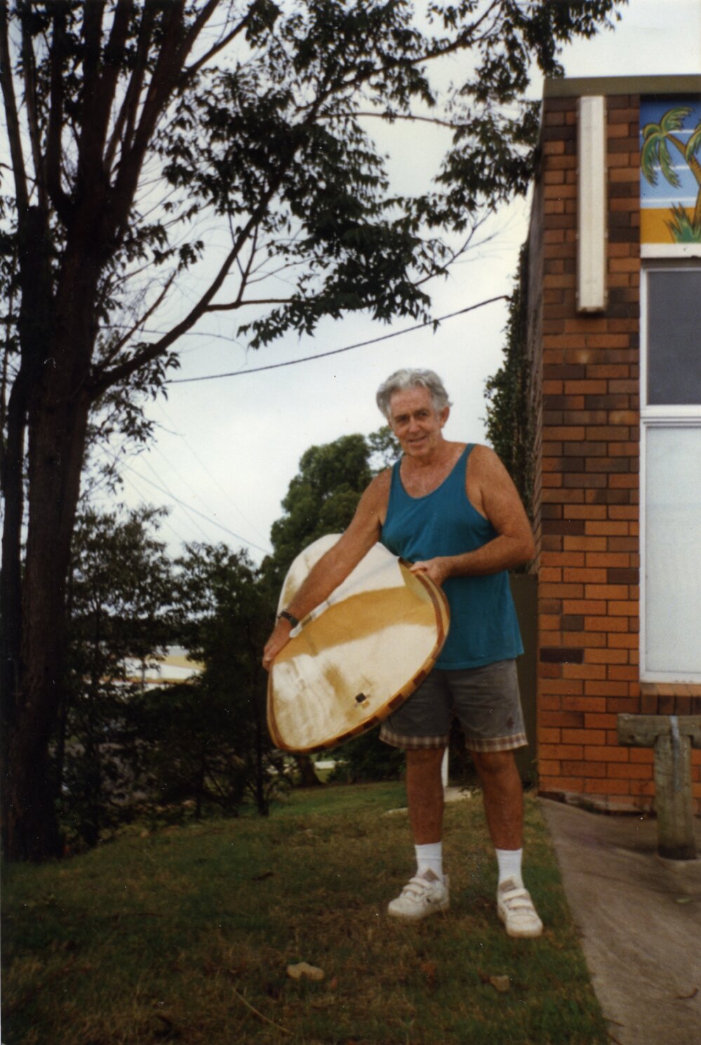 Bill Wallace with his remake timber 'Okanui' surfboard, Noosaville, ca 1990s