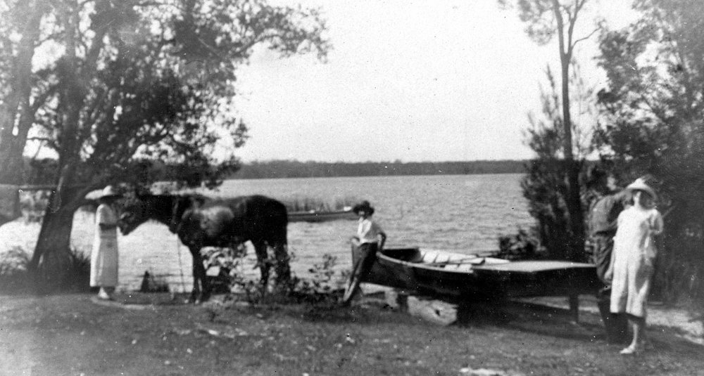 Larard family members launching dinghy, Boreen Point, Lake Cootharaba, 1925 