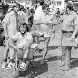 Dan Finch (4NA Commentator) with Peter Holbrook, John Smith and Vic Bruce (Reef Hotel), wheelbarrow race winners, Festival of Waters, Noosaville, 26 August 1973