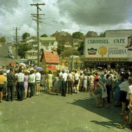 Crowds outside Carousel Cafe, cnr Mary Street and Calton Hill, Gympie Centenary Procession, Gympie, 14 October 1967