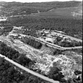 Aerial view, land clearing, David Low Way in foreground, 1970