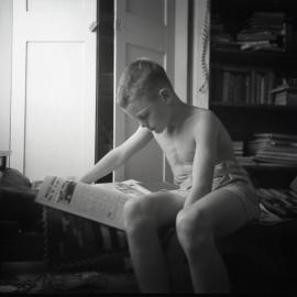 Catching up on the news, ca 1950s