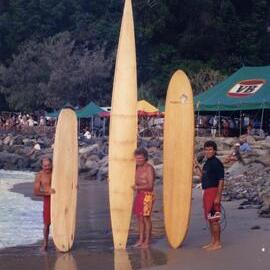 Norm Brokenborough, Midget Farrelly, Peter Biden (L-R) and timber surfboards, Noosa Main Beach, Noosa Heads, ca 1990s