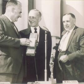 David A. Low (MLA, Speaker), Noel Burke (T.M. Burke Pty. Ltd. ), Cr Stanley Adams (Chairman, Noosa Shire Council (l-r),  official opening, Peregian Roadhouse, Peregian Beach, 2 June 1962