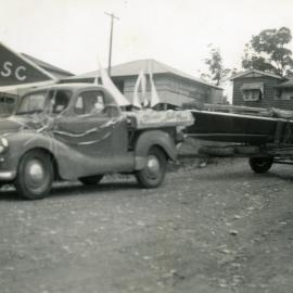 Decorated vehicle and boat, Coronation Day Parade, Lake Cootharaba Sailing Club, 2 June 1953