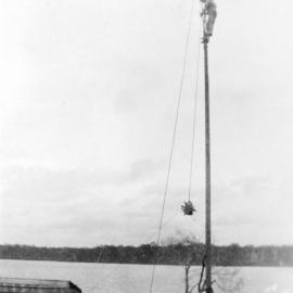 Installing wind generator behind Parkyn family house, Doonella Street, Tewantin, 1934 