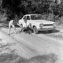 Coral Goldsworthy and Doug Partington, road testing Ford Escort, Louis Bazzo Drive, Boreen Point,  May 1970
