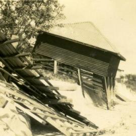 Damaged Ladies and Men's dressing sheds after cyclone,  Noosa Main Beach, Noosa Heads, 21 February 1954