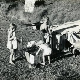 Dominique and Fenton Walsh (standing) with Elissa and Carl Freeman, building a cubby, 'Driftwood', Morwong Drive, Noosa Heads, 6 April 1969