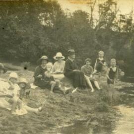 Family group beside a river, ca 1920s