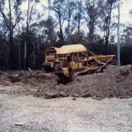 Bulldozers pulling Noosa River Ferry up onto land for survey, mid 1990s