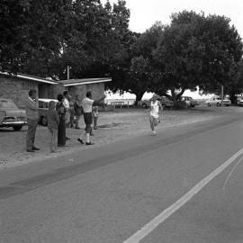 Competitor Brian Nanyon and spectators, footraces, Festival of Waters, Gympie Terrace, Noosaville, 2 September 1972